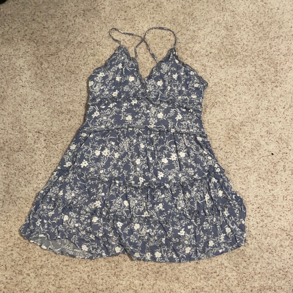 Super cute blue flowy dress. Never worn of the damage in the third picture.